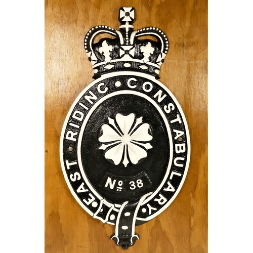 272 - A cast metal replica East Riding Constabulary badge, no 38, 58cm, mounted on a plywood mount