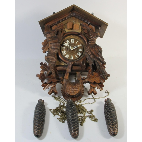 A German carved softwood cuckoo wall clock, with Regula, West Germany