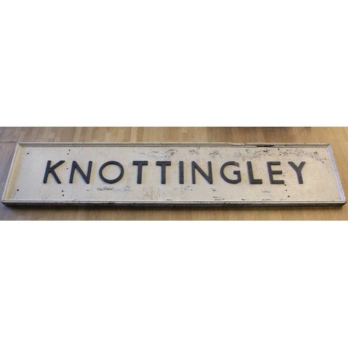 133 - A wooden 'Knottingley' running-in board with cast iron letters and fittings, 64 x 311 cm