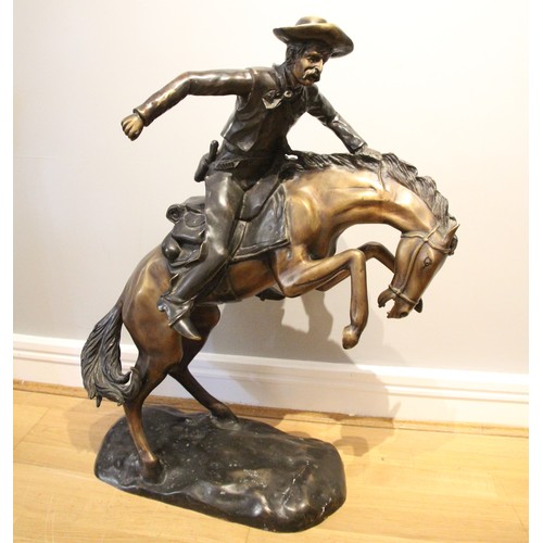 72 - After Frederick Remmington, bronco buster a bronze group, modelled as a cowboy on a rearing horse, u... 