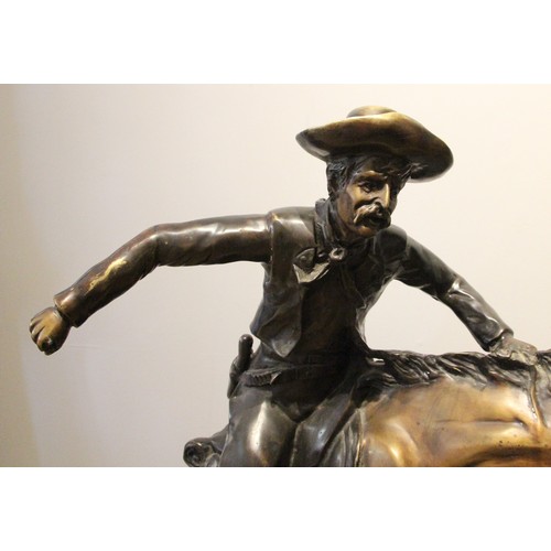 72 - After Frederick Remmington, bronco buster a bronze group, modelled as a cowboy on a rearing horse, u... 