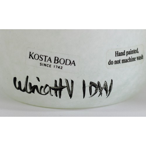 86 - A Kosta Boda Open Minds vase, designed by Ulrika Hydman-Vallien, on a mottled white and yellow groun... 