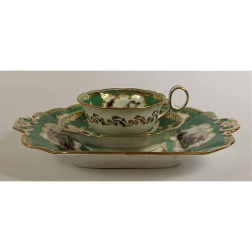 107 - A late 19th century trio, possibly Coalport, decorated with buildings, gilt borders and apple green ... 