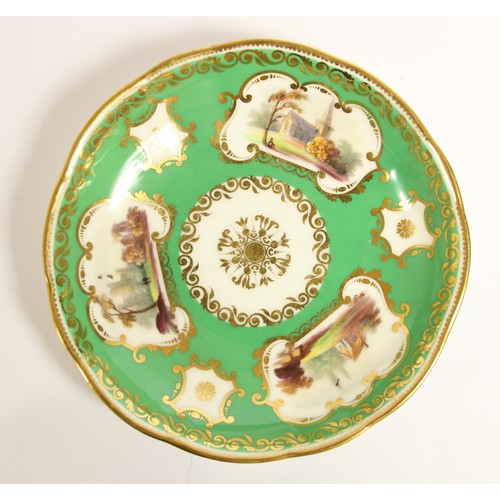 107 - A late 19th century trio, possibly Coalport, decorated with buildings, gilt borders and apple green ... 