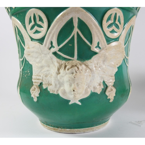 119 - A Puginist Gothic green planter with winged cherub detail, 20 x 22cm, another smaller example, 17 x ... 