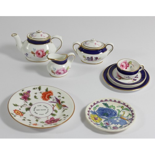 133 - A Coalport Titania miniature tea service, comprising tea pot, sugar bowl, milk jug, cup, saucer and ... 