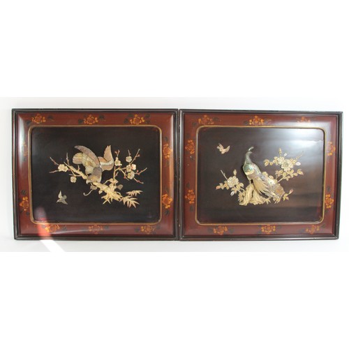 144 - A Chinese pair of lacquer panels with applied mother of pearl peacock and bird amongst branches deco... 