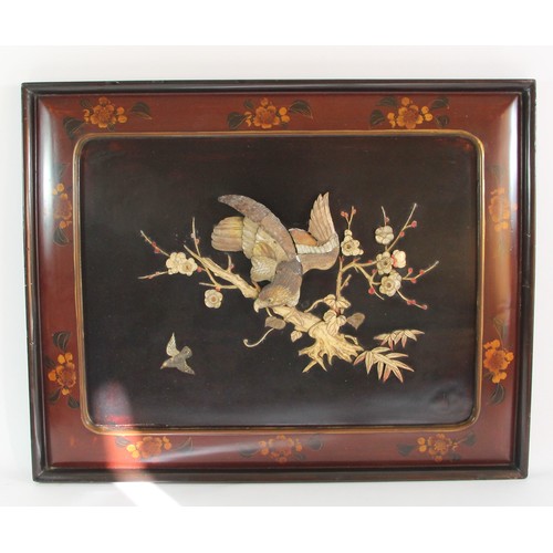 144 - A Chinese pair of lacquer panels with applied mother of pearl peacock and bird amongst branches deco... 