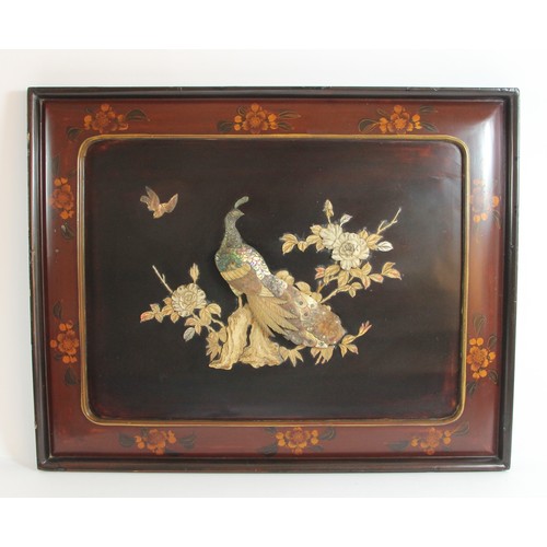 144 - A Chinese pair of lacquer panels with applied mother of pearl peacock and bird amongst branches deco... 