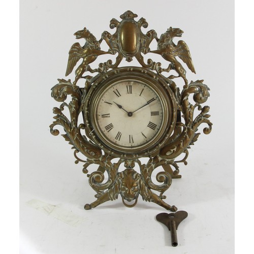 221 - A Victorian cast brass easel mantle clock, the frame with Griffins either side of a shield, floral s... 