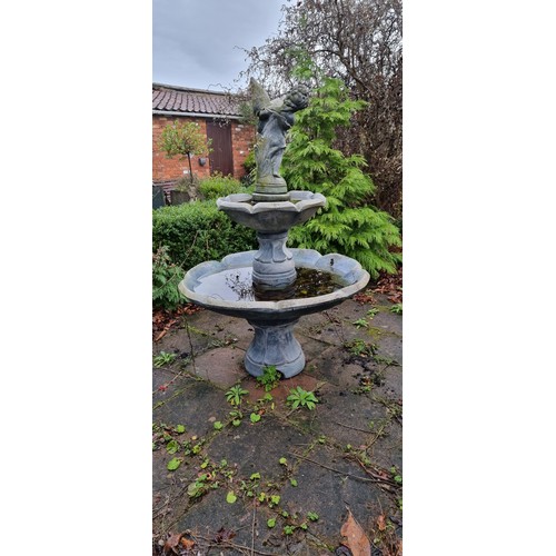 265 - A two tier cast stone effect water fountain, by Hand Studio c.1979, the child holding a dove surmoun... 