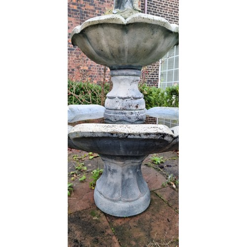 265 - A two tier cast stone effect water fountain, by Hand Studio c.1979, the child holding a dove surmoun... 