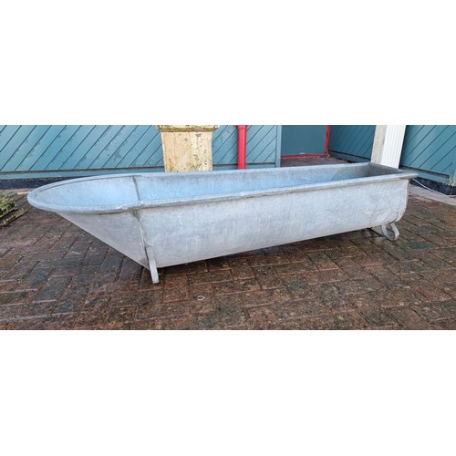 267 - A coffin shaped galvanised trough, by Constantia, raised on scroll supports, 175cm