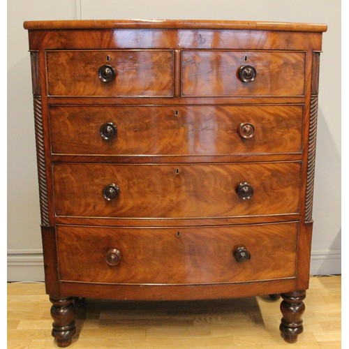 272 - A Victorian bow front mahogany chest of two short over three graduated long drawers, turned pillars,... 