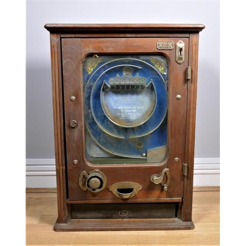 310 - An Allwin De Luxe penny slot machine, c.1920's, oak cabinet, with internal metal ball track, pierced... 