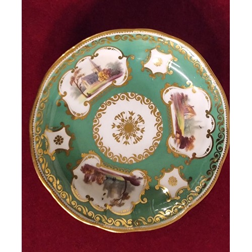 107 - A late 19th century trio, possibly Coalport, decorated with buildings, gilt borders and apple green ... 