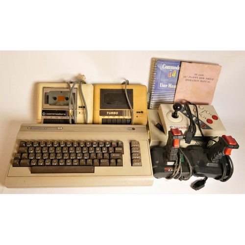 18 - A Commodore 64 (serial No WGB 70246), with manual, a Commodore Datassette (serial No 413954), a Turb... 