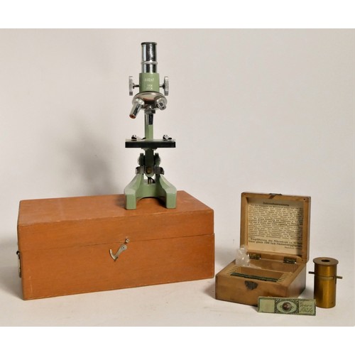 125 - A Regent microscope, boxed, together with a German made unbranded brass microscope, three slides, bo... 