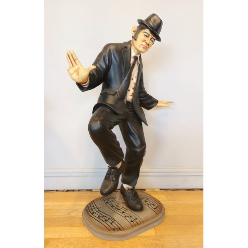 167 - A pair of resin figures, The Blues Brothers, hollow cold cast resin, wooden bases, decorated with mu... 