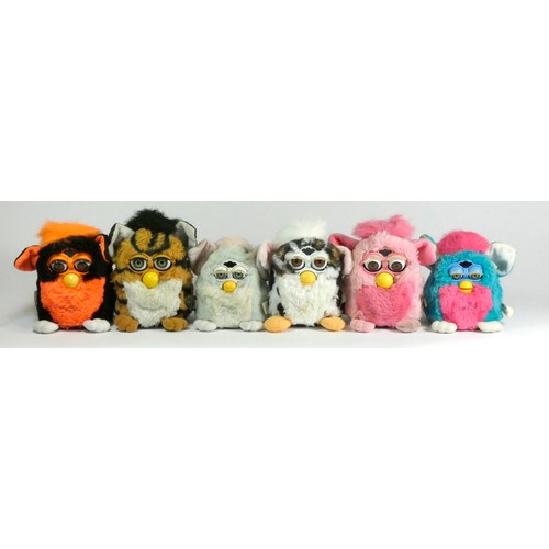 179 - Four Classic Furbies robotic toys, c.1998, all with material tag (one with purple plastic tag), toge... 