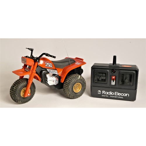 181 - A Shinsei Honda ATC250R radio control 3-whell sports racers, original box and manual, together with ... 