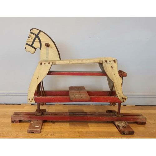 188 - A painted wooden framed child's rocking horse, fabric mane, floating on metal brackets, 110cm x 78cm... 