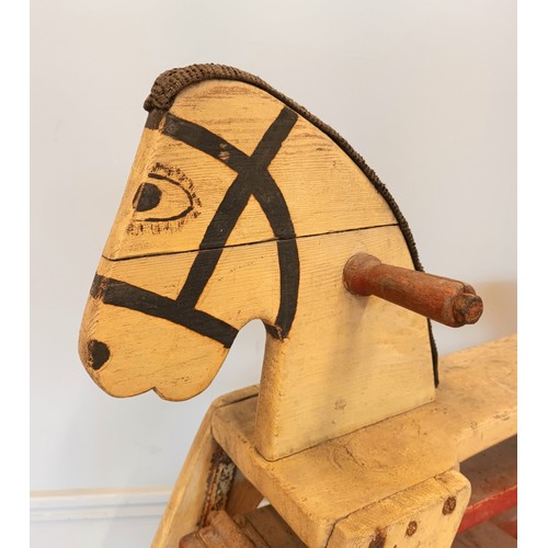 188 - A painted wooden framed child's rocking horse, fabric mane, floating on metal brackets, 110cm x 78cm... 