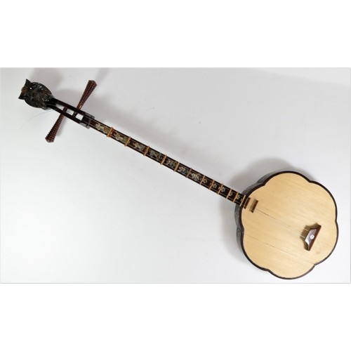 203 - A traditional Vietnamese Dan Sen two string lute, carved flower shaped body with oriental floral car... 