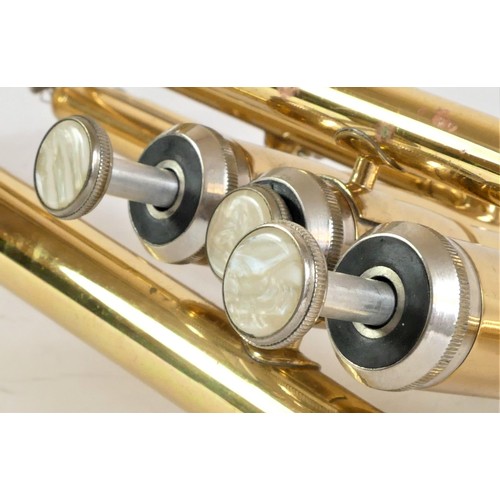 204 - A Jazzo trumpet with silver plated mouth piece, mother of pearl inlay buttons, white cotton gloves a... 