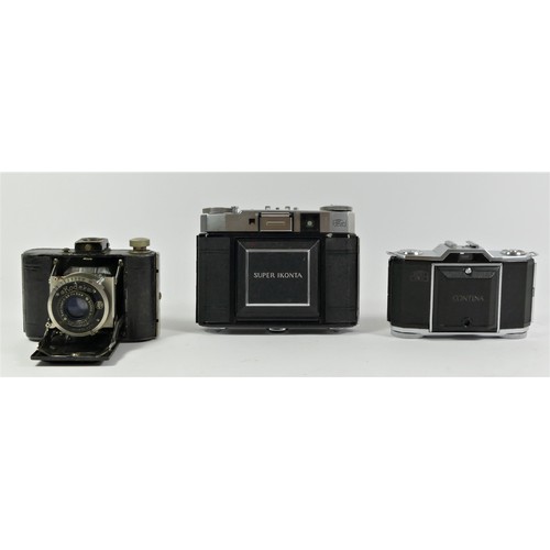 119 - A Zeiss Ikon Super Ikonta III CRF camera, tessar lens, cased and manual, a Zeiss Ikon Contina 522/24... 