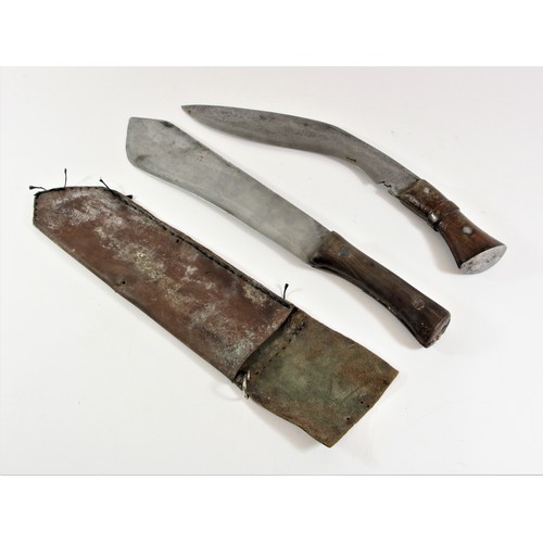 311 - A mid 20th century machete, wooden grip, length of blade31cm and a similar vintage kukri, blade leng... 