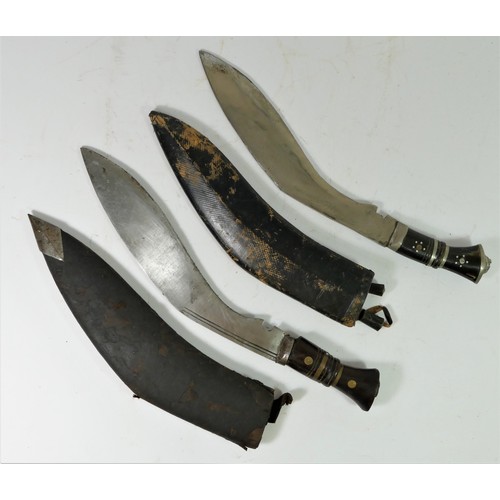 313 - An Indian kukri, the 30cm blade pick dot decorated with two smaller knives to the scabbard and anoth... 