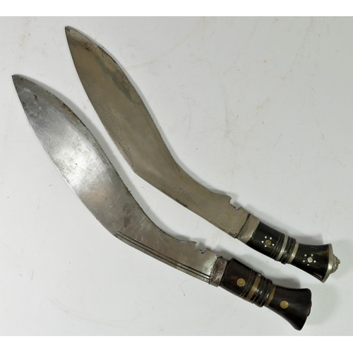 313 - An Indian kukri, the 30cm blade pick dot decorated with two smaller knives to the scabbard and anoth... 