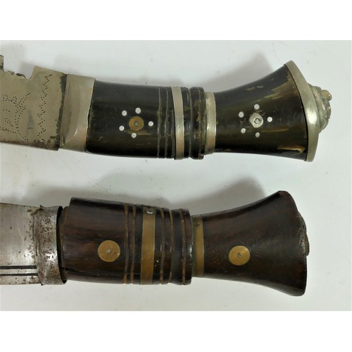 313 - An Indian kukri, the 30cm blade pick dot decorated with two smaller knives to the scabbard and anoth... 