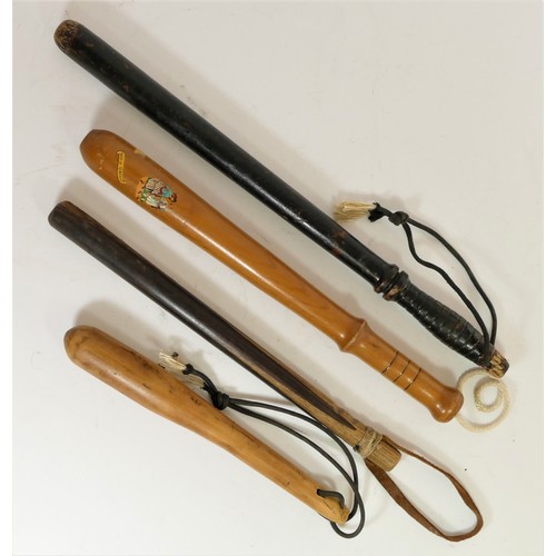 323 - A 19th century ebonised baton, stamped 72, 56cm, together with three later batons (4)