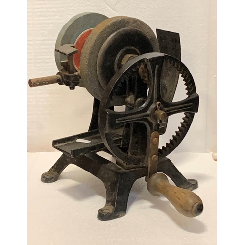 A cast iron manual grinder, two grinding wheels, adjustable tool rail, wooden handle, 32cm tall, tog