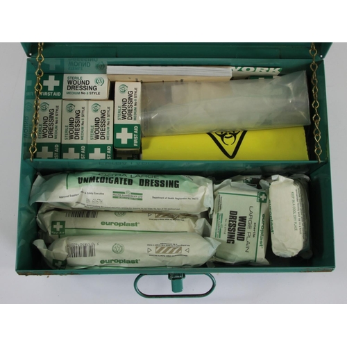 64 - A B.R green first aid tin with numerous contents, predominantly bandages and dressings.