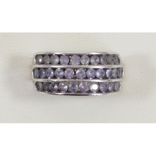 155 - A 9ct white gold and three row Tanzanite ring, channel set with brilliant cut stones, O, 5.1gm
