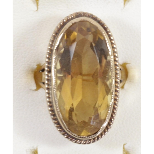 156 - A 9ct gold and citrine dress ring, collect set with an oval mixed cut stone, 23 x 12mm, L, 8.4gm