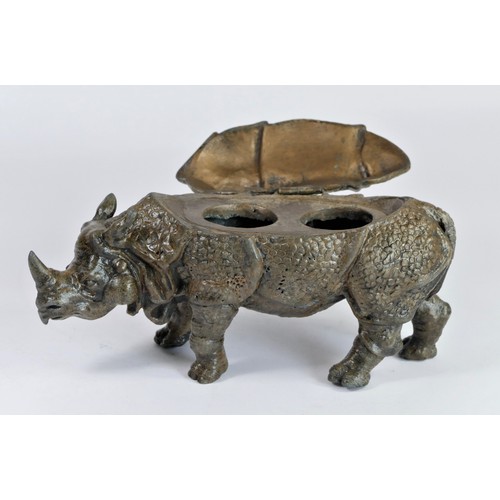 185 - An early 20th century cold painted metal model of a Rhinoceros, the back opening to reveal two inkwe... 