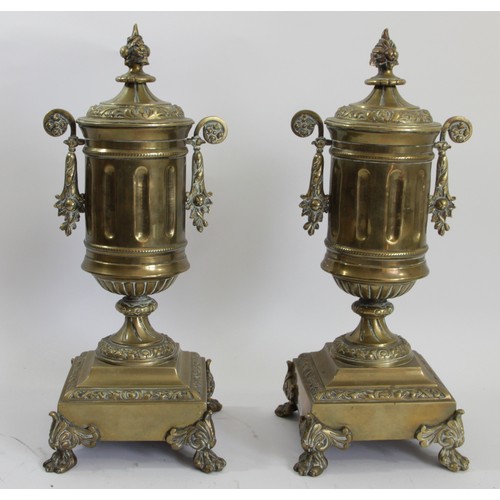 192 - A pair of late 19th century brass garnitures, of twin handled form, raised on a square base with scr... 