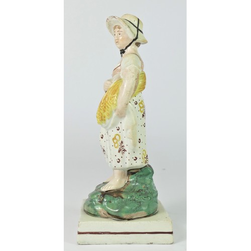 251 - A pearlware figurine of Summer, c.1800-1820, modelled as a girl with sickle and sheath of corn, in e... 