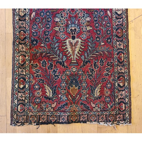 214 - A Persian Sarouk runner with multicoloured floral decorations, 280 x 80 cm