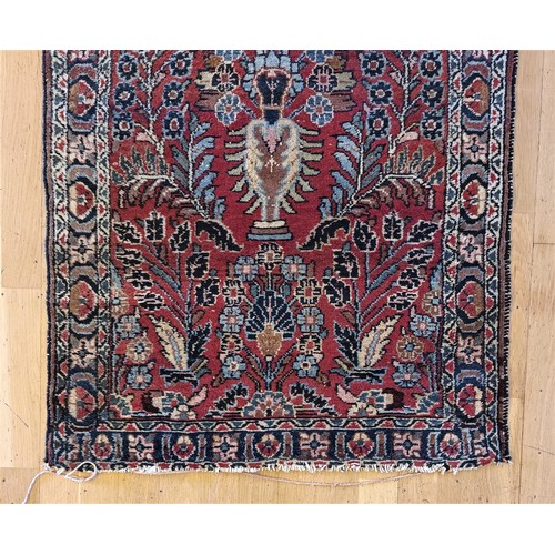 214 - A Persian Sarouk runner with multicoloured floral decorations, 280 x 80 cm