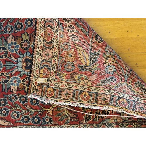 214 - A Persian Sarouk runner with multicoloured floral decorations, 280 x 80 cm