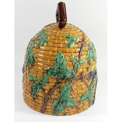257 - A large majolica pottery beehive stilton dish and cover, possibly Minton, moulded with flowering vin... 