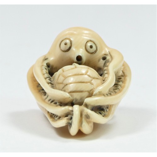 279 - A Meiji period carved ivory netsuke of an octopus fighting a turtle, bears signature, 4cm.