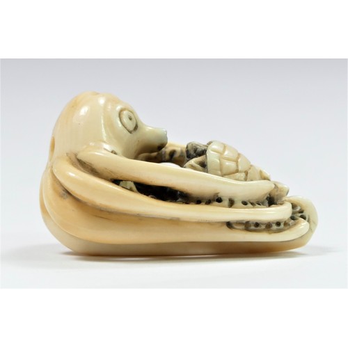 279 - A Meiji period carved ivory netsuke of an octopus fighting a turtle, bears signature, 4cm.