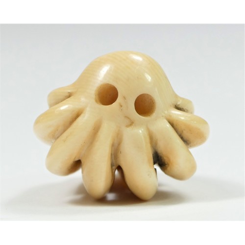 279 - A Meiji period carved ivory netsuke of an octopus fighting a turtle, bears signature, 4cm.