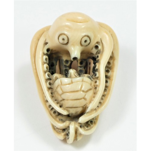 279 - A Meiji period carved ivory netsuke of an octopus fighting a turtle, bears signature, 4cm.